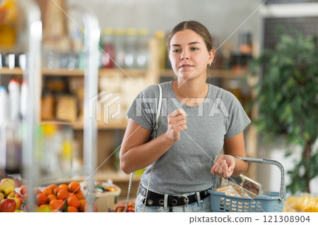 Young woman choosing food in grocery store Young woman choosing food in grocery store 121308904