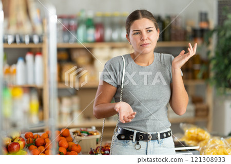 Thoughtful woman in a supermarket 121308933