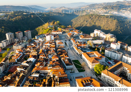 Drone view of Vila Real cityscape with viaduct crossing Corgo River in background 121308996
