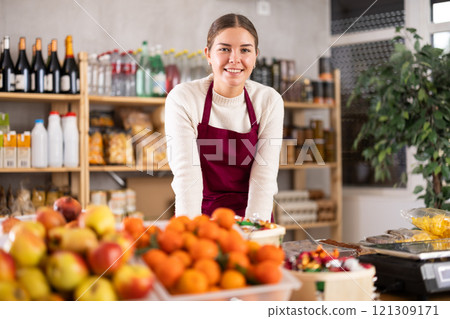 Smiling saleswoman behind the store counter 121309171
