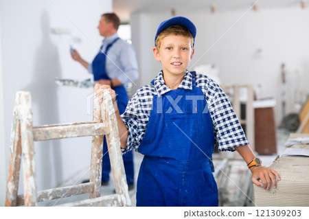 Preteen boy posing on indoor construction site Preteen boy posing on indoor construction site 121309203