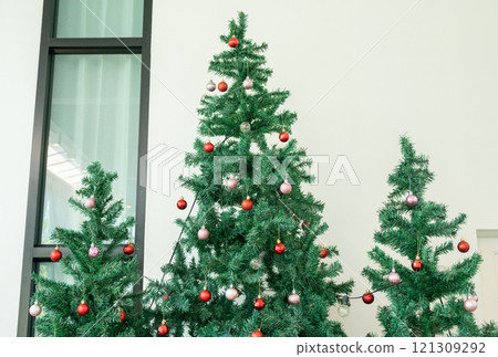 Decorated Christmas tree in house during Christmas festival and New Year celebration. Decorated Christmas tree in house during Christmas festival and New Year celebration. 121309292