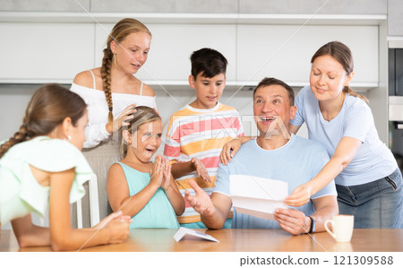 Family reading letter with good news 121309588