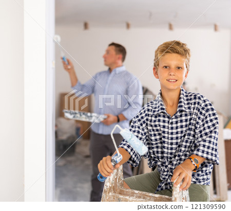 Portrait of positive young boy with paint roller Portrait of positive young boy with paint roller 121309590