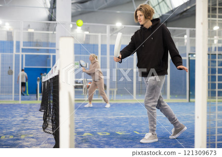 Portrait of a guy tennis player playing padel 121309673