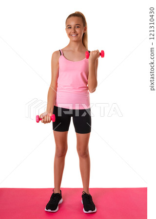 Healthy fitness teen girl in full length doing exercises with dumbbells isolated over white background Healthy fitness teen girl in full length doing exercises with dumbbells isolated over white background 121310430