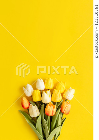Bouquet of tulips on a yellow background Artificial flowers Spring flower background material Bouquet of tulips on a yellow background Artificial flowers Spring flower background material 121310561