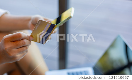 Online banking transaction concept, Woman with credit card using smart phone and shopping online, Ecommerce and secure mobile banking concept, Making online payments. Online banking transaction concept, Woman with credit card using smart phone and shopping online, Ecommerce and secure mobile banking concept, Making online payments. 121310667