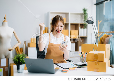 Startup small business SME, Entrepreneur owner woman using smartphone or tablet taking receive and checking online purchase shopping order Startup small business SME, Entrepreneur owner woman using smartphone or tablet taking receive and checking online purchase shopping order 121310880