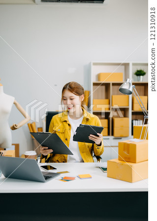 Asian lady blogger showing clothes in front of the camera to recording vlog video live streaming 121310918