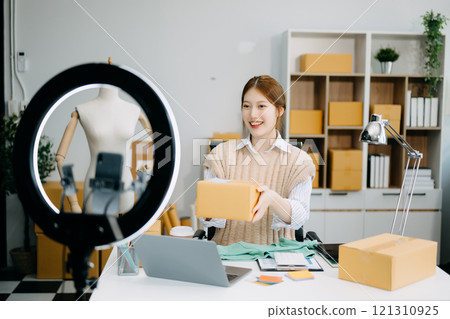 Fashion blogger concept, Young Asian women selling clothes on video streaming.Startup small business SME Fashion blogger concept, Young Asian women selling clothes on video streaming.Startup small business SME 121310925