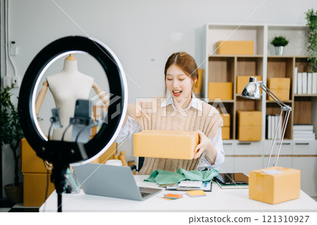 Fashion blogger concept, Young Asian women selling clothes on video streaming.Startup small business SME 121310927