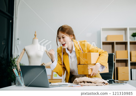 Startup small business SME, Entrepreneur owner woman using smartphone or tablet taking receive and checking online purchase shopping order Startup small business SME, Entrepreneur owner woman using smartphone or tablet taking receive and checking online purchase shopping order 121310985