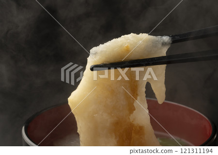 Picking up the mochi in ozoni with chopsticks Picking up the mochi in ozoni with chopsticks 121311194