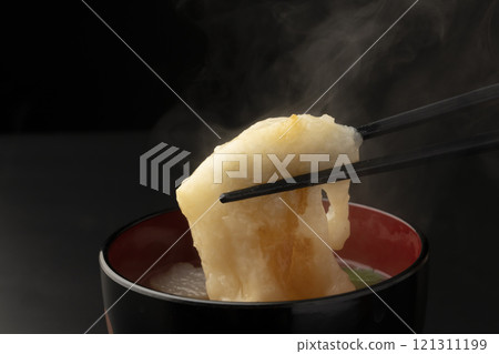 Picking up the mochi in ozoni with chopsticks Picking up the mochi in ozoni with chopsticks 121311199