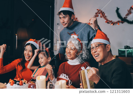 Happy family with gifts celebrating Christmas together 121311603