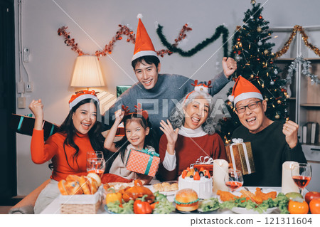 Happy family with gifts celebrating Christmas together 121311604