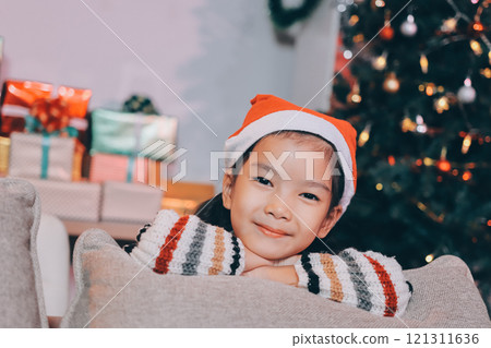 christmas, x-mas, winter, happiness concept - dreaming girl in santa helper hat 121311636