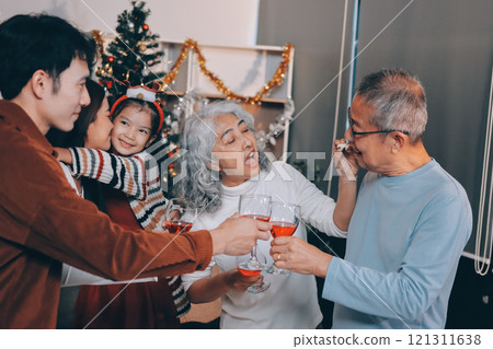 Merry Christmas! Happy family are having dinner at home. Celebration holiday and togetherness near tree. Merry Christmas! Happy family are having dinner at home. Celebration holiday and togetherness near tree. 121311638