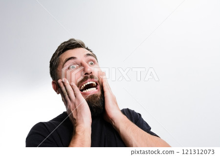 Shocked man with hands on face Shocked man with hands on face 121312073