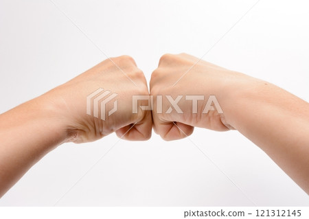 Two fists touching against a white background Two fists touching against a white background 121312145