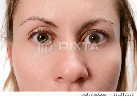 Close-up of a woman's surprised face Close-up of a woman's surprised face 121312158
