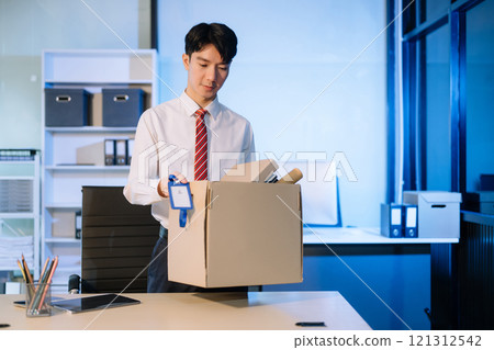 young Asian man office worker celebrating her resignation, carrying her personal stuff. leaving job, changing or company young Asian man office worker celebrating her resignation, carrying her personal stuff. leaving job, changing or company 121312542