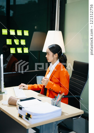 Business woman using tablet and laptop for doing math finance on an office desk, tax Business woman using tablet and laptop for doing math finance on an office desk, tax 121312756