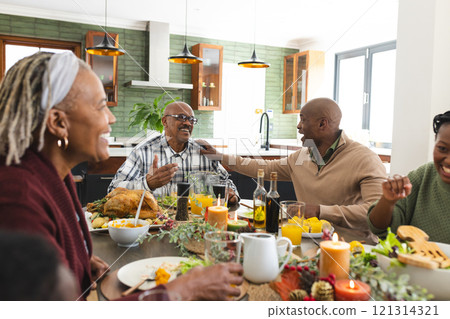African american parents, children and grandparents celebrating at thanksgiving dinner 121314321