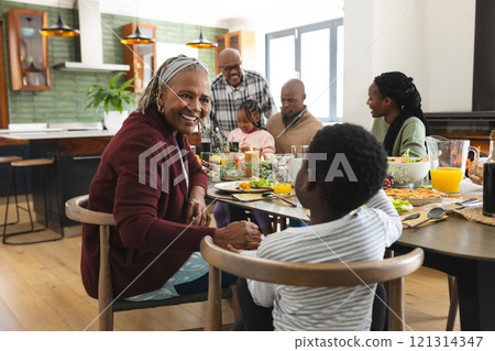 African american parents, children and grandparents celebrating at thanksgiving dinner 121314347