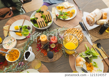 Thanksgiving dinner celebrating by african american parents, children and grandparents 121314357