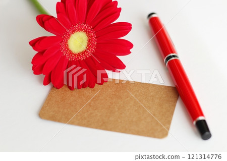 Brown message card, red gerbera and red fountain pen 121314776