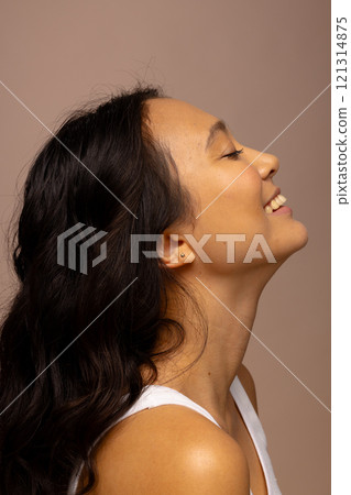 Profile of happy asian woman with dark hair and closed eyes 121314875
