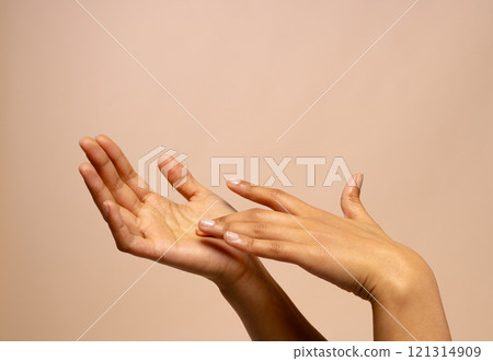 Touching hands of biracial woman on pink beige background with copy space Touching hands of biracial woman on pink beige background with copy space 121314909