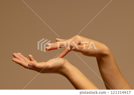 Touching hands of biracial woman on brown background with copy space Touching hands of biracial woman on brown background with copy space 121314917