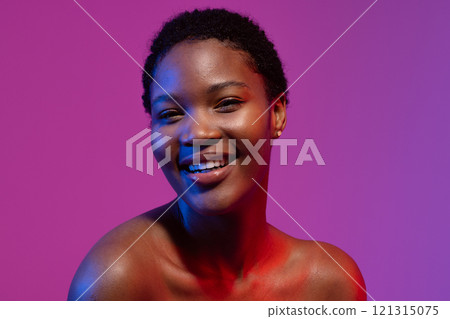 African american woman with short hair smiling in blue and red light on purple background African american woman with short hair smiling in blue and red light on purple background 121315075