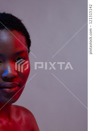 Half portrait of african american woman with short hair in blue and red light, copy space Half portrait of african american woman with short hair in blue and red light, copy space 121315142