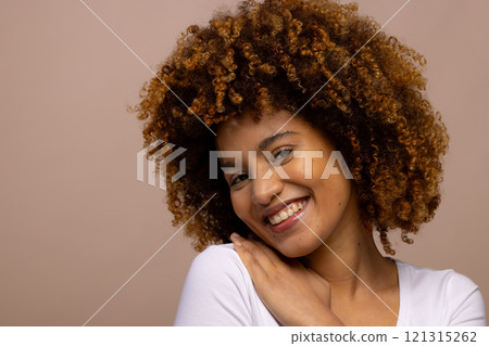 Biracial woman with curly hair, smiling with hand on shoulder 121315262