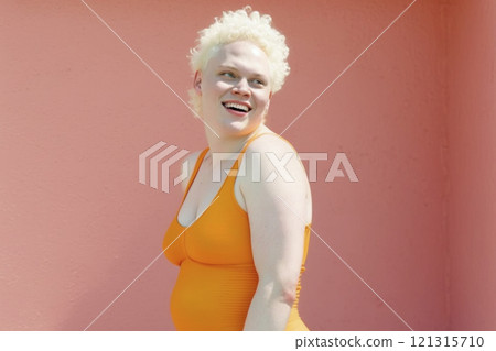 Portrait of smiling non-binary albino person on bright background created with ai generative tools. 121315710