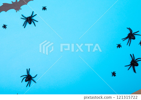 Multiple spider and bat toys with copy space on blue background 121315722