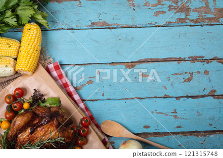 Cooked chicken and multiple food ingredients with copy space on blue wooden surface 121315748