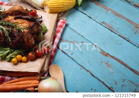 Cooked chicken and multiple food ingredients with copy space on blue wooden surface 121315749