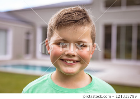 Portrait of smiling caucasian boy with brown hair standing at backyard outside house Portrait of smiling caucasian boy with brown hair standing at backyard outside house 121315789