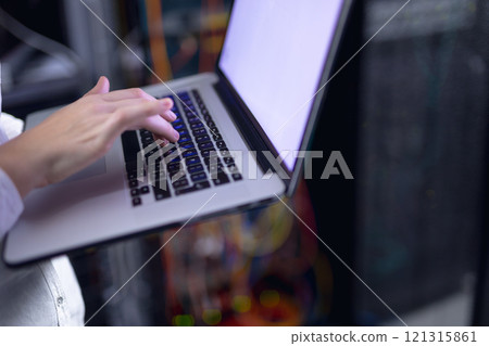 Mid section of woman laptop in computer server room Mid section of woman laptop in computer server room 121315861