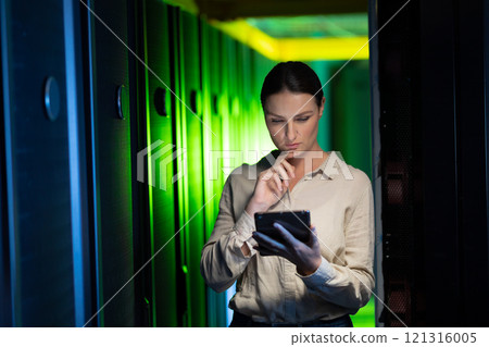 Thoughtful caucasian female engineer using digital tablet in computer server room Thoughtful caucasian female engineer using digital tablet in computer server room 121316005
