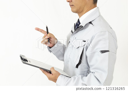 A man wearing work clothes inspecting something on a white background A man wearing work clothes inspecting something on a white background 121316265