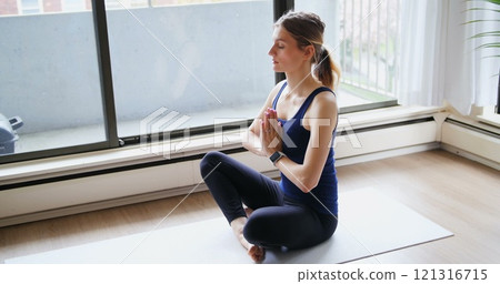 Beautiful woman performing yoga at home 4k Beautiful woman performing yoga at home 4k 121316715