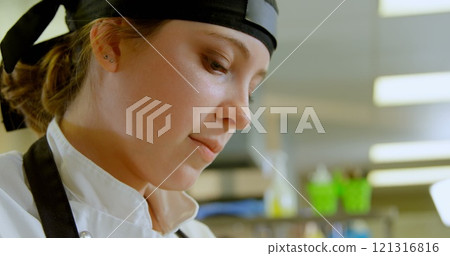 Close-up of female chef working in kitchen at restaurant 4k 121316816