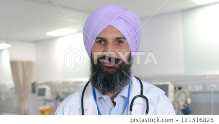 Portrait of happy biracial sikh male doctor in turban looking at camera at hospital, in slow motion Portrait of happy biracial sikh male doctor in turban looking at camera at hospital, in slow motion 121316826