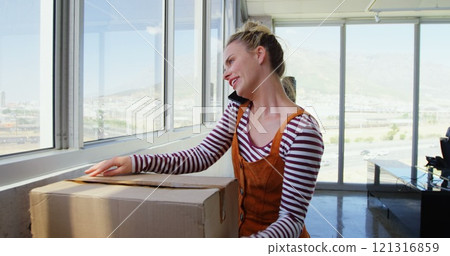 Front view of Caucasian Businesswoman talking on mobile phone in the office 121316859
